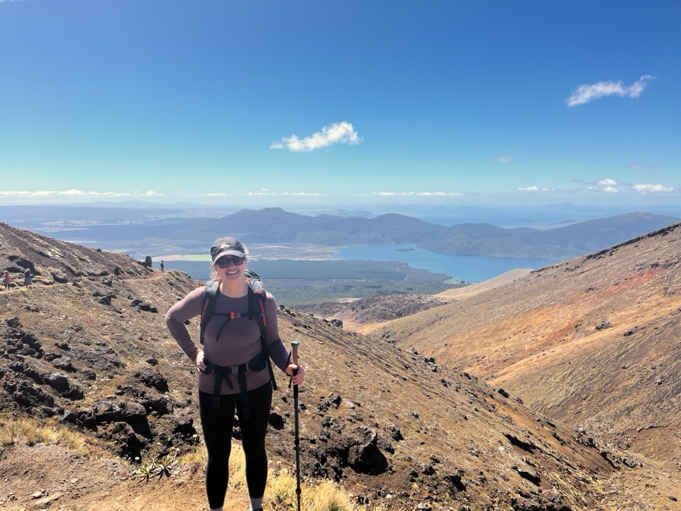 Heather hiking the Tongariro crossing, lake behind her